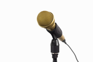 Golden microphone on a stand on white background