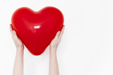 hands holding heart. happy valentine's day concept. red heart balloon on white background with...