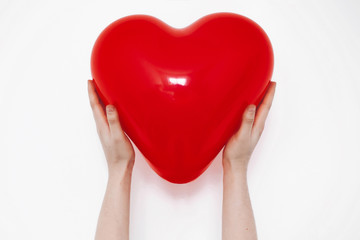 Obraz premium red heart in hands, isolated on white. happy valentine's day concept. healthcare, medicine and blood donation donor concept. love and protection . space for text.