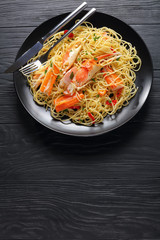 tasty spaghetti with Crab on black plate