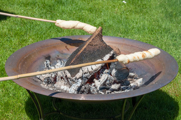 Bread baking over open fire - Snobrød