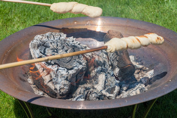 Bread baking over open fire - Snobrød