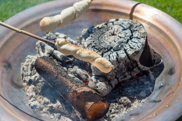 Bread baking over open fire - Snobrød