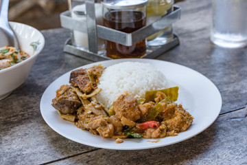 Curry and rice on a white plate.