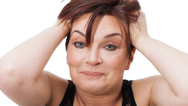 Beautiful and funny woman portrait pulling her hair with amused look