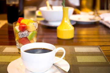 Healthy breakfast fruit salad and  cup of coffee