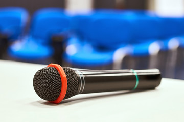 Black microphone on the table in empty auditorium