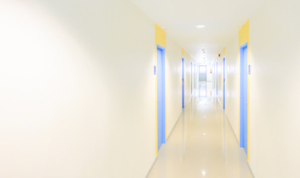 Blur hallway concept for hotel,hospital,office,dorm or apartment with copy space.Hallway to hotel rooms with blue doors.