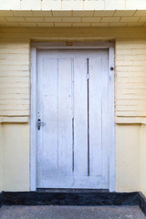 Old wooden house door White wooden wall texture background.