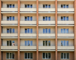 Fototapeta premium Facade of a house residential building windows with white wooden sash