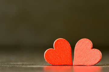 Red hearts on black background. Valentine`s concept background.