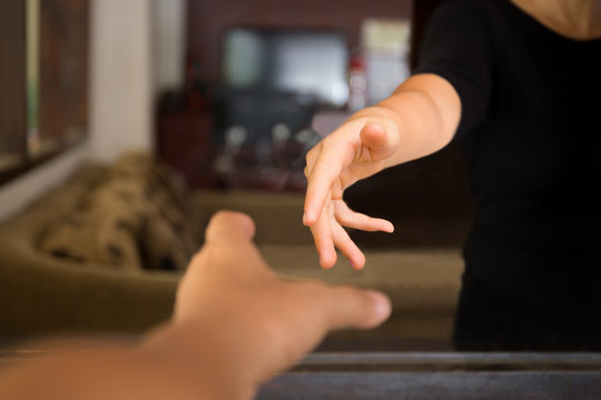 Male hands reaching out to help woman