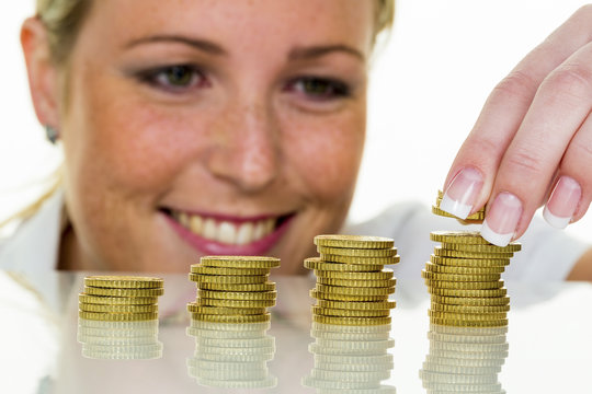 woman with coin stack while saving money