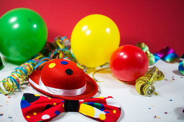 Party hat with bow, balloons and streamers