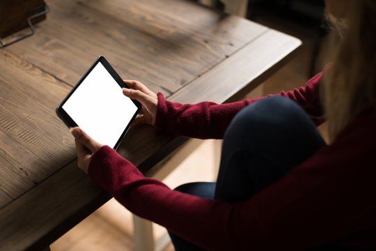 Young woman using tablet at home