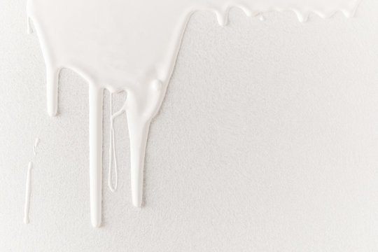 white dripping paint on white surface