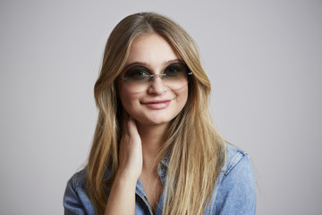 Smiling young woman in cool shades, portrait