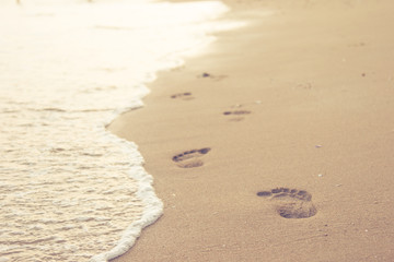 Close up of human footprints on the sand beach, Selective focus.