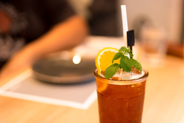 Iced tea with lemon and mint on the table