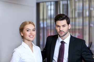 Fototapeta na wymiar businessman and businesswoman standing at reception desk in hotel