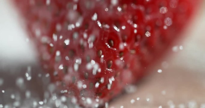 Strawberry in white sugar shot in super slow motion