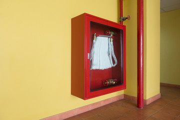 Fire extinguisher and fire hose reel in an apartment