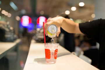 Hand pouring healthy mineral water into glass