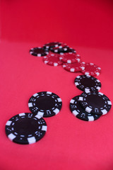 Poker chips on red background.
