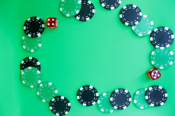 Poker chips on green background.