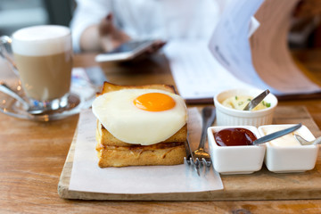 Toast cheese sandwiches with fried egg and coffee with businesswoman working