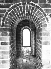 Ancient arch in China, old brick wall and floor texture in b/w. Use as background, backdrop, image montage in vintage or retro style; or visual content relate to historical and architectural studies.
