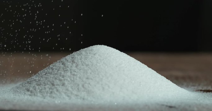Falling sugar cane granules shot on high speed camera, phantom flex
