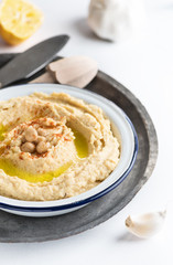 Chick-pea classic hummus in a dish with olive oil and paprika. Copy space