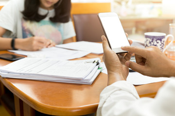 Businessman using cell phone working with partner in finance tax accounting