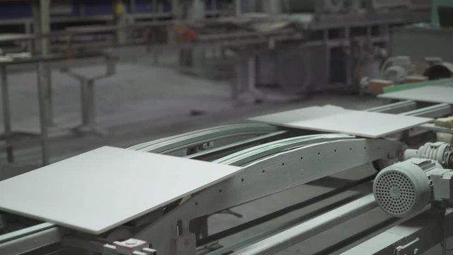 Production of ceramics, ceramic tiles are moving on the conveyor.
