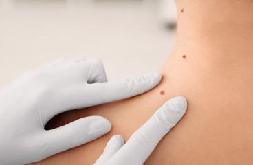 Oncologist examining patient in clinic. Cancer awareness