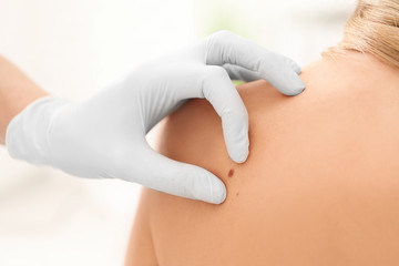 Oncologist examining female patient in clinic. Cancer awareness