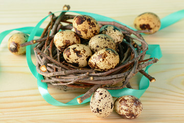 Quail eggs with ribbon in nest