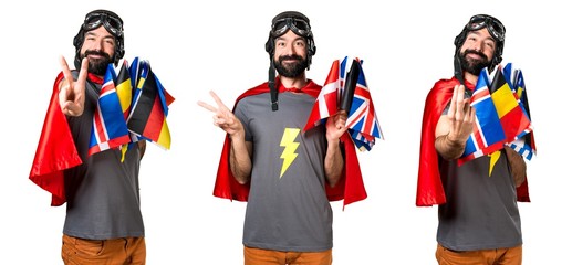 Superhero with a lot of flags making victory gesture