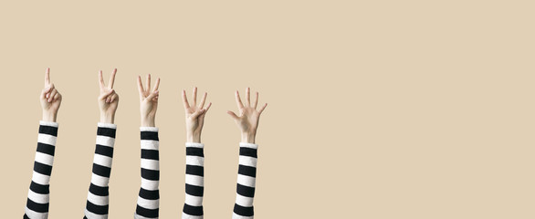 Raised up hands and fingers showing numerical