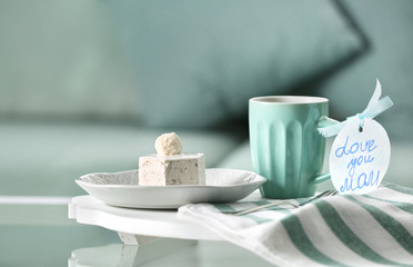 Tasty dessert, cup of coffee and card with words 