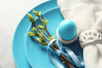 Beautiful festive Easter table setting with painted egg, closeup