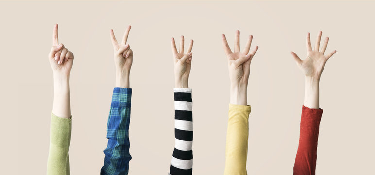 Raised up hands and fingers showing numerical