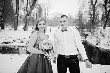 Amazing couple in winter fairytale forest in love. Girl in red beautiful dress. Valentine's Day theme.