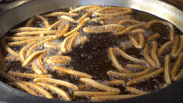 close up on Churros fry in the oil