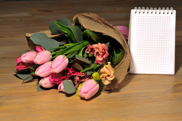 bouquet of tulips on the table with a note