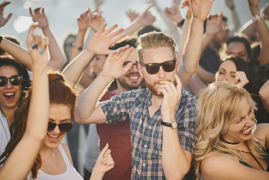     Group of people dancing and having a good time at the outdoor party/music festival 