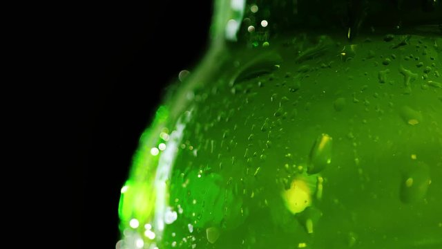 Close-up of a piece of a bottle of beer. The caplets are covered. It fights against a black background. Quench your thirst concept