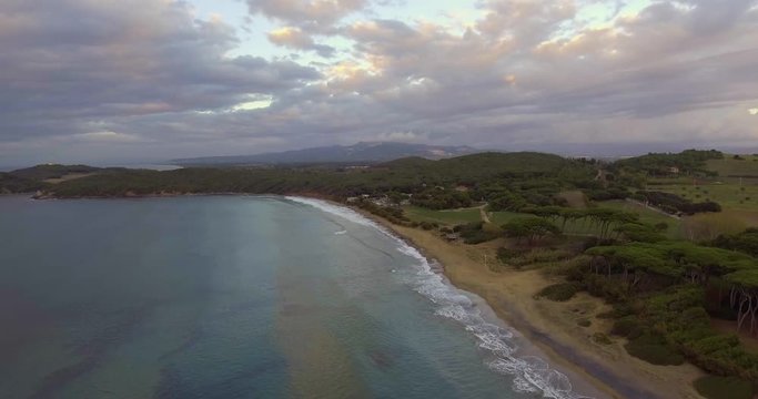 Aerial, beautiful sea waves by the beach on a cloudy evening