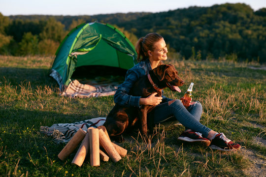 Happy Woman Traveling With Dog On Weekend In Nature.